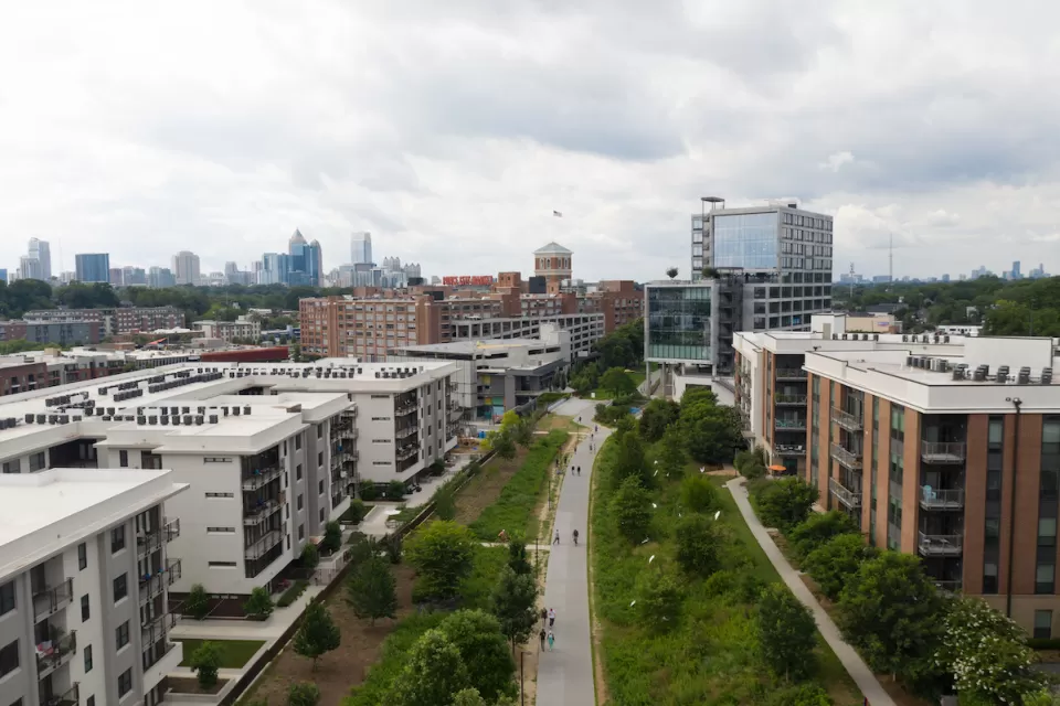 Aerial view of Atlanta BeltLine greenway with multistory buildings one ither side